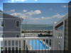 129 WEST SPRUCE AVENUE  INLET CONDOS #2 - NORTH WILDWOOD SUMMER VACATION RENTALS with POOLS at WILDWOODRENTS.COM - Three bedroom, two bath vacation home with view of the inlet! Home offers a full kitchen with range, fridge, dishwasher,  disposal, microwave, coffeemaker and blender. Amenities include central a/c, wifi, pool, balcony, outside shower, storage area, 2 car garage, 1 car driveway. Sleeps 6: 1 Queen, 4 Twins. (full air mattress avail). North Wildwood Rentals, Wildwood Rentals, Wildwood Crest Rentals and Diamond Beach Rentals in all price ranges for weekly, monthly, seasonal and weekend vacation rentals plus Wildwood real estate sales of homes, condos, vacation and investment properties in and around Wildwood New Jersey. We offer over 400 properties plus exclusive vacation homes so you can book the shore rental of your choice online and guarantee your vacation at the Shore. Rent with confidence at Island Realty Group! Visit www.wildwoodrents.com to book online or call our office at 609.522.4999. Our office at 1701 New Jersey Avenue in North Wildwood is open 7 days a week!
