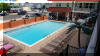 1605 OCEAN AVENUE  BRIGADOON CONDOS #212 - NORTH WILDWOOD BEACHBLOCK SUMMER VACATION RENTALS with POOLS at WILDWOODRENTS.COM managed by ISLAND REALTY GROUP, NORTH WILDWOOD REALTORS AND VACATION RENTAL MANAGEMENT - Welcome to your perfect beachside getaway in North Wildwood! This charming property is ideal for a family of up to 6 guests, offering 2 bedrooms and 1 full bathroom for your comfort and convenience. As you step inside, you'll find a cozy and well-appointed living space with all the amenities you need for a relaxing stay. The kitchen is fully equipped with a dishwasher, microwave, coffee maker, toaster, stove, and full-size refrigerator, making meal preparation a breeze. Enjoy your meals at the dining table or head out to the deck to dine al fresco with deck furniture and a gas BBQ grill. After a day at the beach, unwind in the comfortable living room with a sofa bed, smart TV, and high-speed internet access. The property features central AC and ceiling fans to keep you cool during the warmer months. For your convenience, there is a washer, dryer, and shared washer/dryer available on-site. When it's time to rest, the bedrooms offer a variety of sleeping arrangements including a double bed, twin/twin bunk with twin trundle bed. Linens are not provided, so be sure to bring your own. During your stay, take advantage of the outdoor pool, and outside shower shared with other guests. Parking is available for one vehicle. Located in North Wildwood Beach Side, this property is just a short walk away from the sandy shores and sparkling waters of the beach. Explore the local attractions, restaurants, and shops or simply relax and soak up the sun. Please note that this property does not allow pets and is smoke-free. Come and experience the best of beachside living at this North Wildwood retreat. Book your stay today! North Wildwood Rentals, Wildwood Rentals, Wildwood Crest Rentals and Diamond Beach Rentals in all price ranges for weekly, monthly, seasonal and weekend vacation rentals plus Wildwood real estate sales of homes, condos, vacation and investment properties in and around Wildwood New Jersey. We offer over 400 properties plus exclusive vacation homes so you can book the shore rental of your choice online and guarantee your vacation at the Shore. Rent with confidence at Island Realty Group! Visit www.wildwoodrents.com to book online or call our office at 609.522.4999. Our office at 1701 New Jersey Avenue in North Wildwood is open 7 days a week!