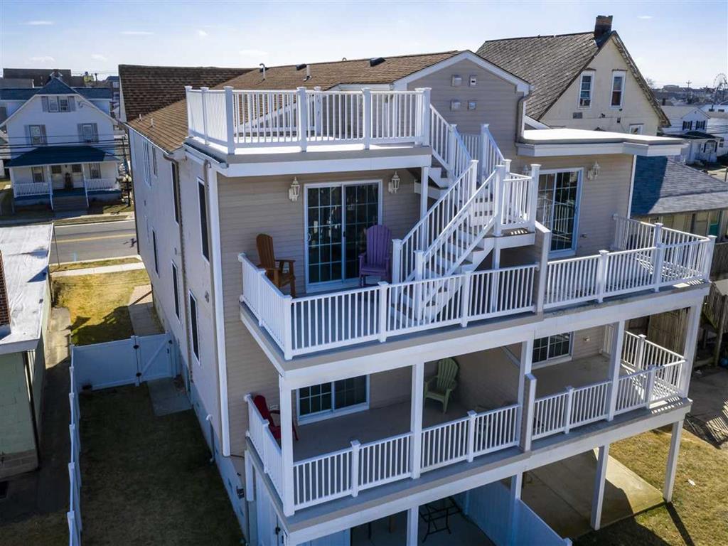 1706 NEW YORK AVENUE  NORTH WILDWOOD TOWNSHOUSE - 5 bedroom, 3 bath townhouse with roof top deck located in North Wildwood. Home offers a full kitchen with range, fridge, dishwasher, disposal, microwave, coffee maker. Amenities include central a/c, washer/dryer, wifi, hot tub, five balconies, outside shower, private fenced yard, gas grill, 2 car off street parking. Sleeps 16; 2 king, 2 queen, 2 double, double futon, and air mattress. North Wildwood Rentals, Wildwood Rentals, Wildwood Crest Rentals and Diamond Beach Rentals in all price ranges for weekly, monthly, seasonal and weekend vacation rentals plus Wildwood real estate sales of homes, condos, vacation and investment properties in and around Wildwood New Jersey. We offer over 400 properties plus exclusive vacation homes so you can book the shore rental of your choice online and guarantee your vacation at the Shore. Rent with confidence at Island Realty Group! Visit www.wildwoodrents.com to book online or call our office at 609.522.4999. Our office at 1701 New Jersey Avenue in North Wildwood is open 7 days a week!