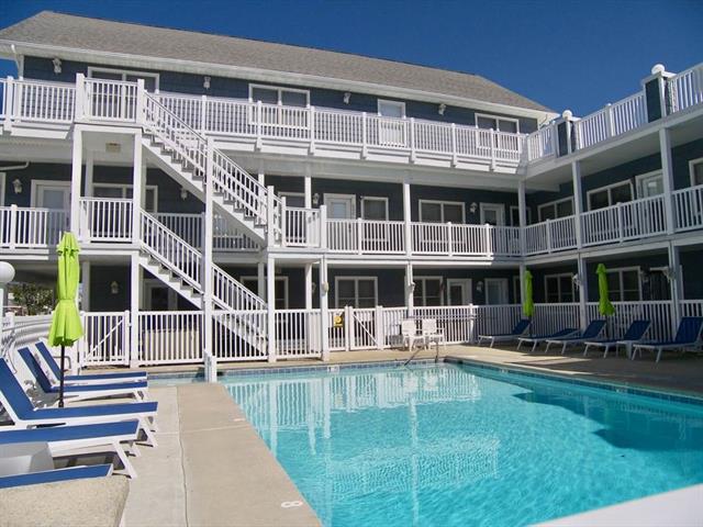 2207 SURF AVENUE  BAYBERRY CONDOS #102 - NORTH WILDWOOD BEACHBLOCK SUMMER VACATION RENTALS with POOLS at WILDWOODRENTS.COM managed by ISLAND REALTY GROUP  - Welcome to your perfect beachside getaway in North Wildwood! This charming property is ideal for a family of up to 6 guests, offering 2 bedrooms and 1 full bathroom for your comfort and convenience. As you step inside, you'll find a cozy living space with modern furnishings and a welcoming atmosphere. The living room features a comfortable sofa bed that can accommodate 2l guests, along with a Smart TV for your entertainment needs.