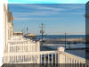505 EAST 15TH AVENUE #201B - NORTH WILDWOOD BEACHBLOCK SUMMER VACATION RENTALS at WILDWOODRENTS.COM managed by ISLAND REALTY GROUP - Welcome to your perfect beach getaway in North Wildwood! This stunning property, located in North Wildwood, offers everything you need for a relaxing and comfortable stay. With 3 bedrooms and 2 full bathrooms, this spacious rental can accommodate up to 8 guests. The sleeping arrangements include a luxurious king bed, a cozy queen bed, and two double beds, ensuring a good night's sleep for everyone. The property is equipped with modern amenities to make your stay as convenient as possible. Enjoy the fully equipped kitchen with a dishwasher, microwave, toaster, stove, full-size refrigerator, oven, and all the necessary cookware and dinnerware. The central AC will keep you cool on hot summer days, while the washer, dryer, iron, and ironing board provide added convenience. Relax in the comfortable living area with cable TV and high-speed internet, or step out onto the balcony to enjoy the fresh sea breeze. Beach equipment, including chairs and umbrellas, is provided for your convenience. This property is smoke-free and does not allow pets, ensuring a clean and allergy-friendly environment for all guests. The enclosed outside shower is perfect for rinsing off after a day at the beach. With a garage and 2-car garage, parking is a breeze. Additional amenities include a Keurig coffee maker, wireless LAN, smart TVs, and beach essentials such as mattress pads, pillows, and beach chairs. Don't miss out on this fantastic rental in North Wildwood! Book now for the perfect beach vacation with family and friends. North Wildwood Rentals, Wildwood Rentals, Wildwood Crest Rentals and Diamond Beach Rentals in all price ranges for weekly, monthly, seasonal and weekend vacation rentals plus Wildwood real estate sales of homes, condos, vacation and investment properties in and around Wildwood New Jersey. We offer over 400 properties plus exclusive vacation homes so you can book the shore rental of your choice online and guarantee your vacation at the Shore. Rent with confidence at Island Realty Group! Visit www.wildwoodrents.com to book online or call our office at 609.522.4999. Our office at 1701 New Jersey Avenue in North Wildwood is open 7 days a week!